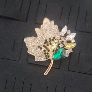 Elegant Gold Tone Leaf Brooch with Green and Silver Accents